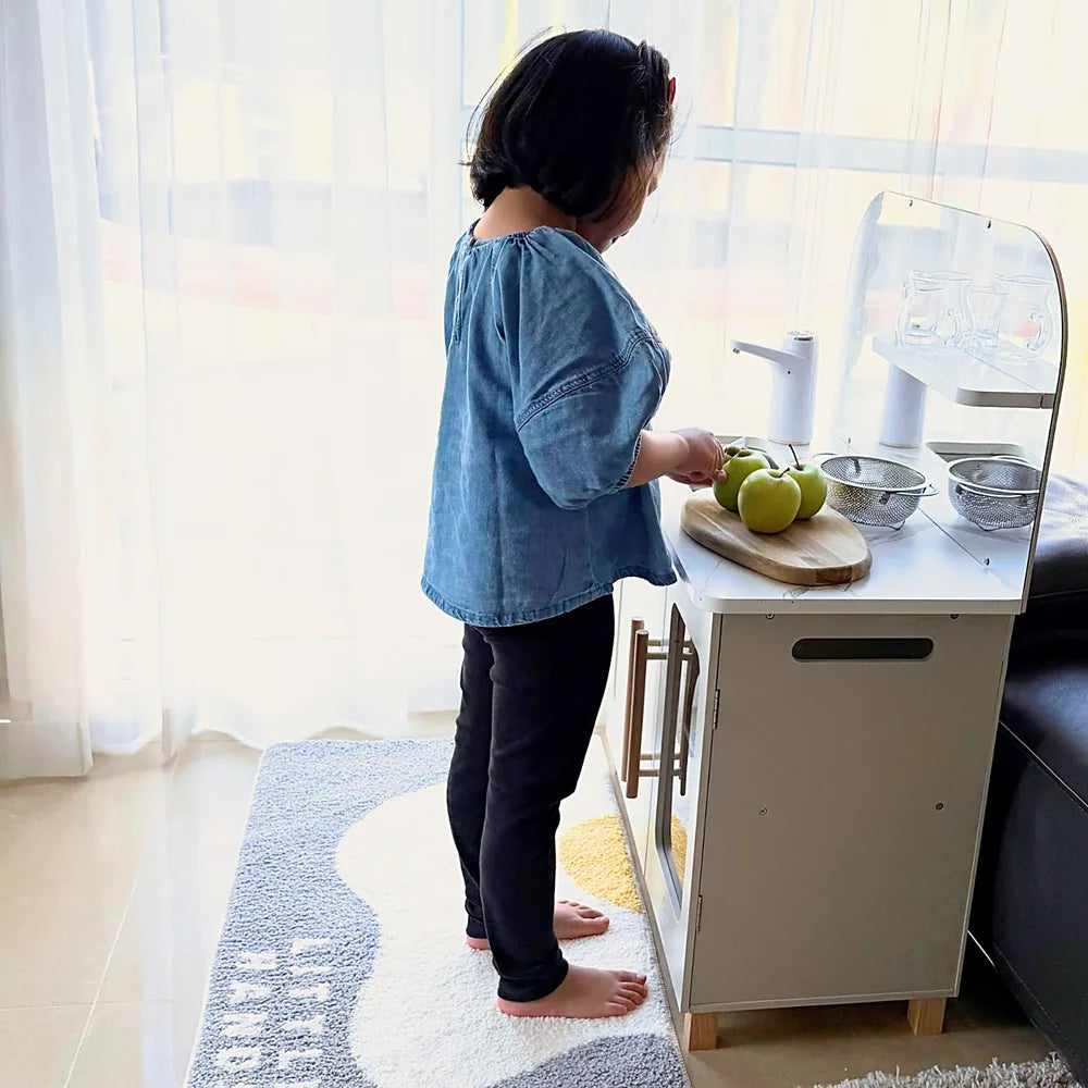 Child preparing apples on the kitchen bench