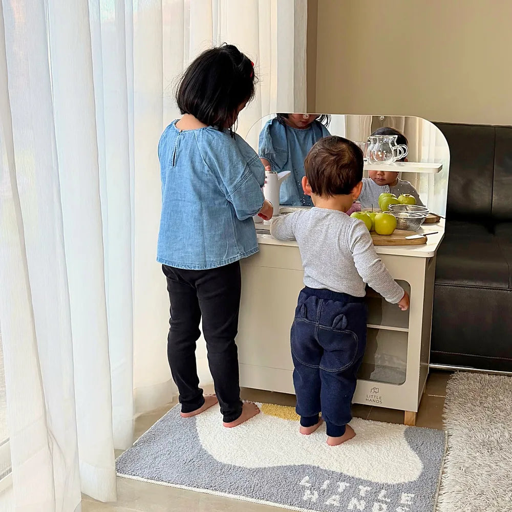 Two children working at the kitchen together